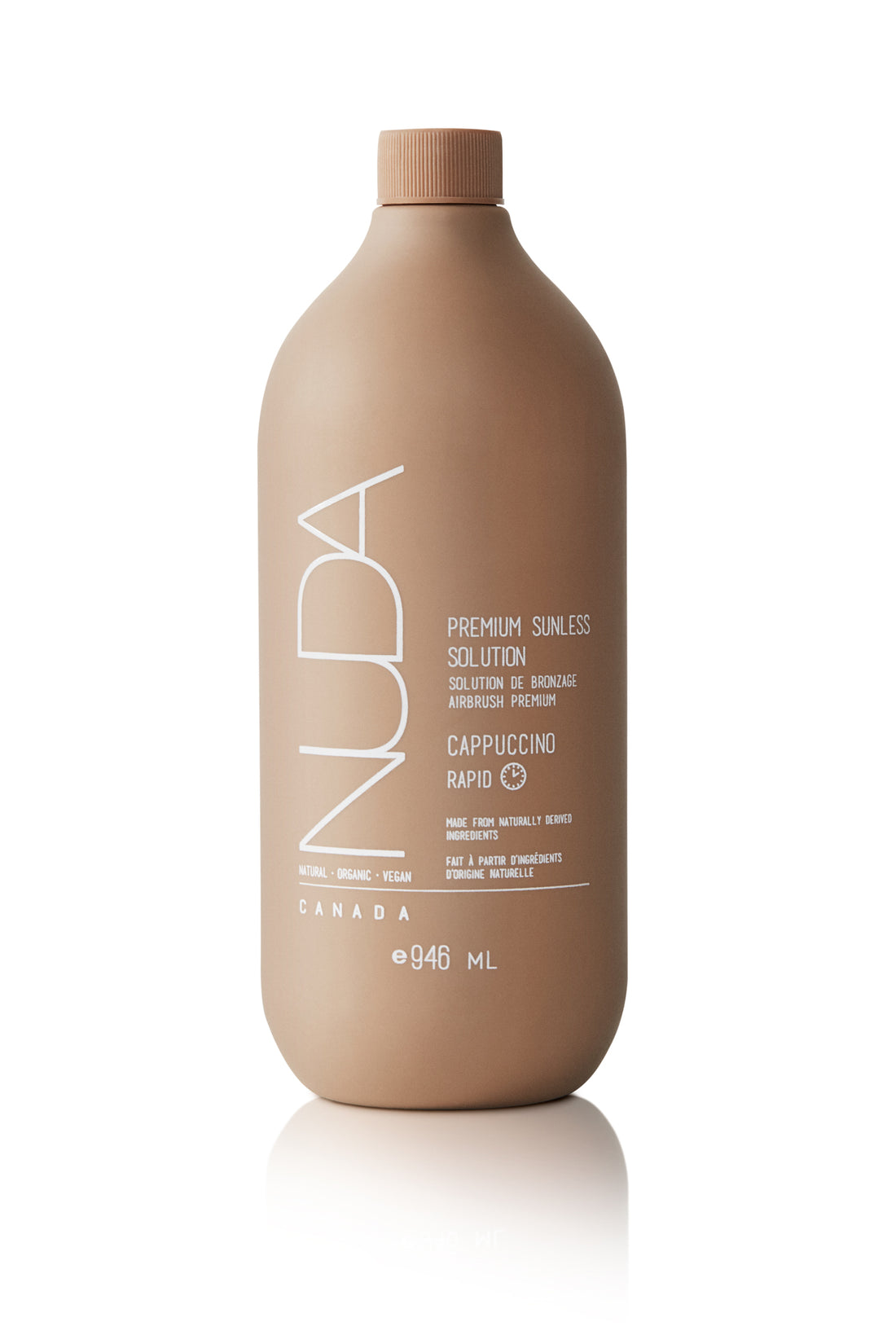 Edgemont A matte brown bottle of nuda sunless tanning solution labeled "premium sunless solution cappuccino" with text indicating it is a vegan product, also noting it is made in canada and contains 946 ml. North Vancouver