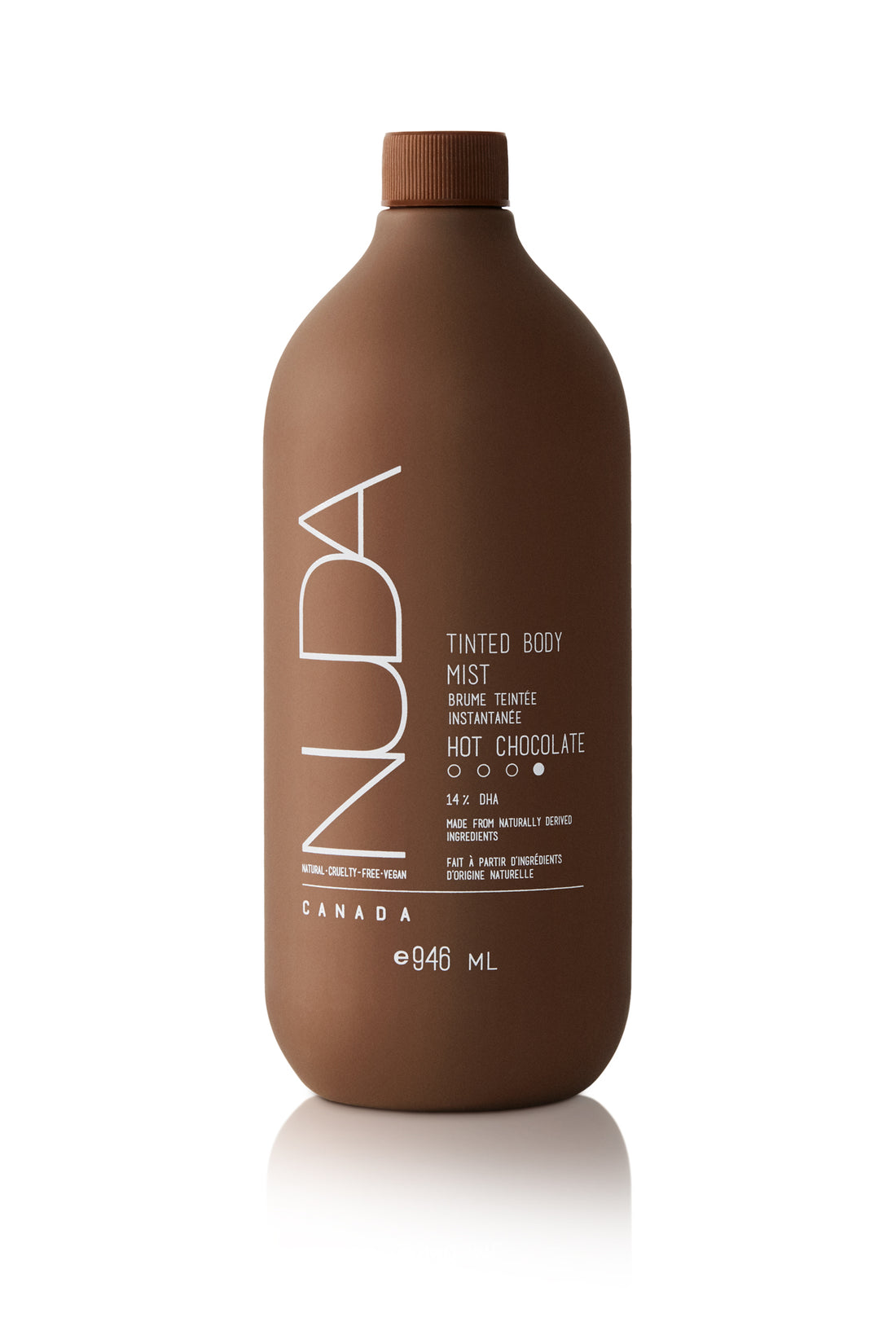 Edgemont A brown opaque bottle labeled "nuda tinted body mist in hot chocolate" with 946 ml capacity, detailing its oil-free and water-resistant properties, against a white background. North Vancouver